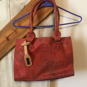 Red artelusa cork bag with dust cover.